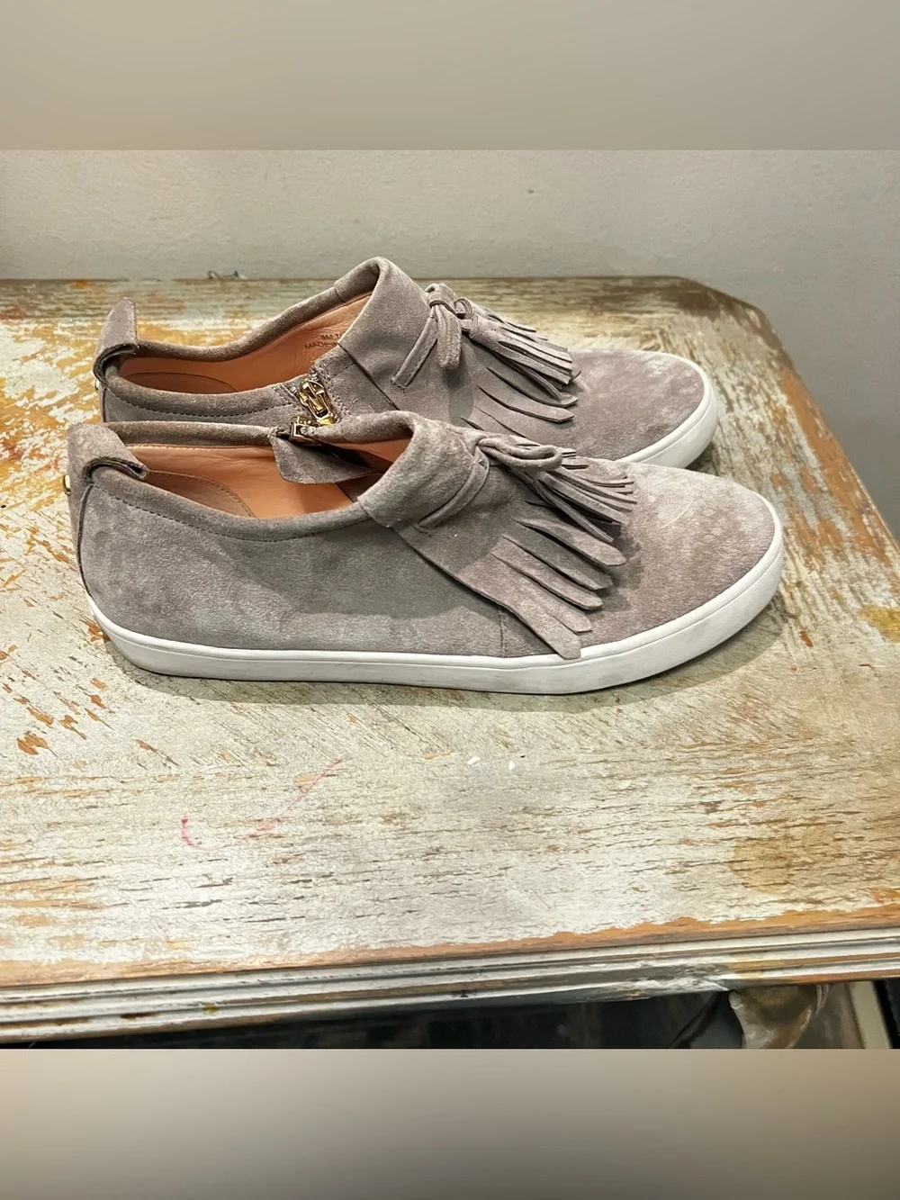 Kate Spade Taupe Gray Suede Fringed Tassel Slip-On Sneakers Gold Tone Side Zip